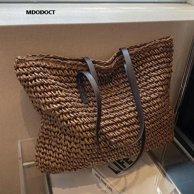 a brown and black bag on a white box