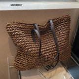 a brown and black bag on a white box