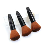 three brushes on a white background