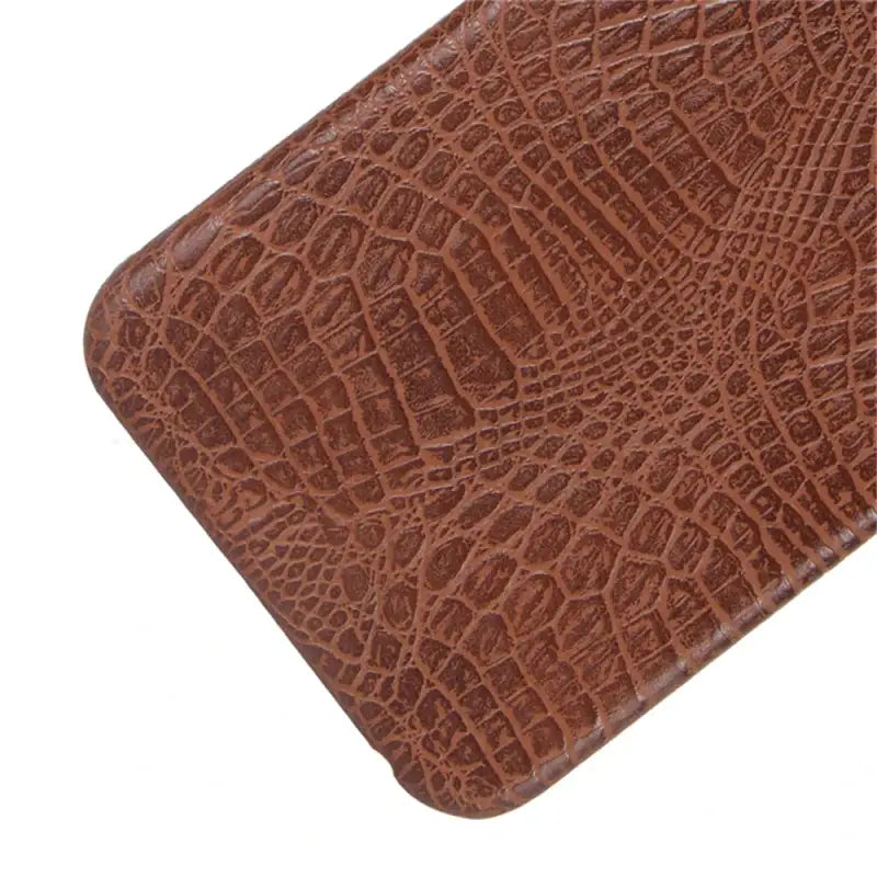 A brown crocodile skin case for the iphone