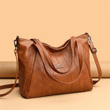 a brown leather bag with a zipper closure