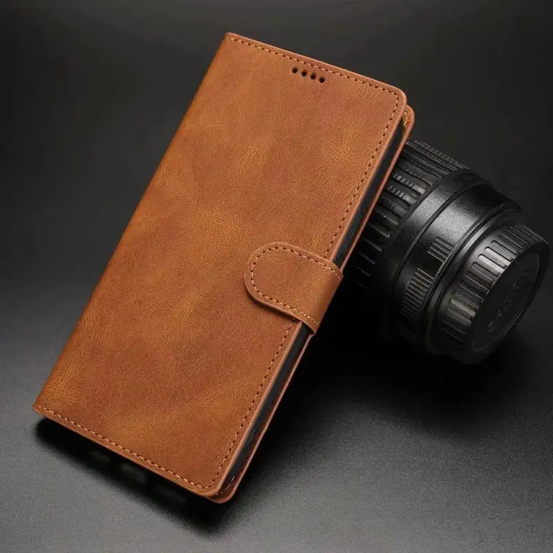 a brown leather case with a camera and lens