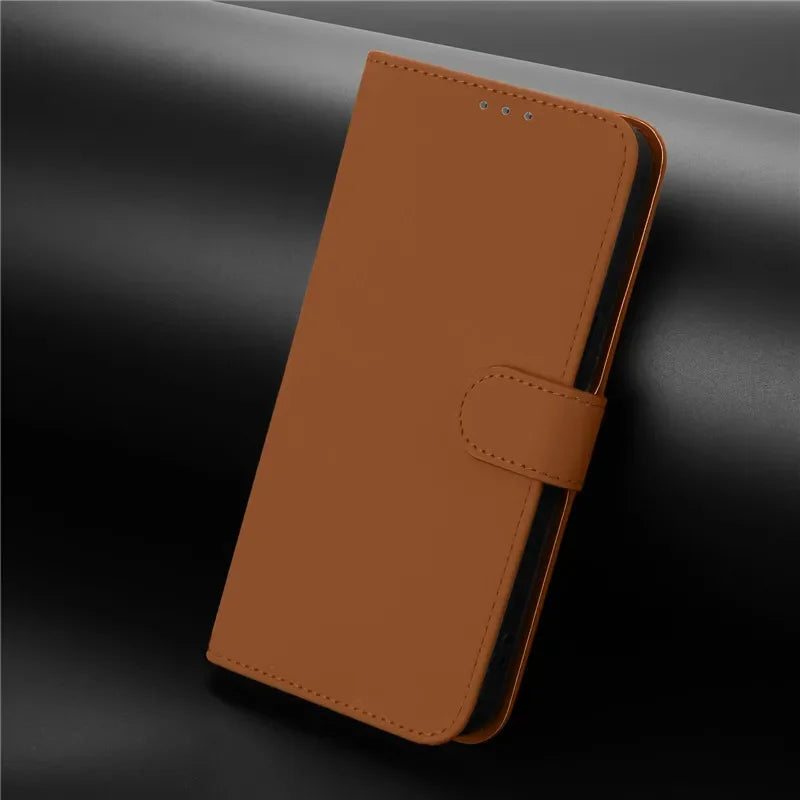 Brown leather flip phone case with a magnetic closure strap.