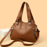 a brown leather handbag with a zipper closure