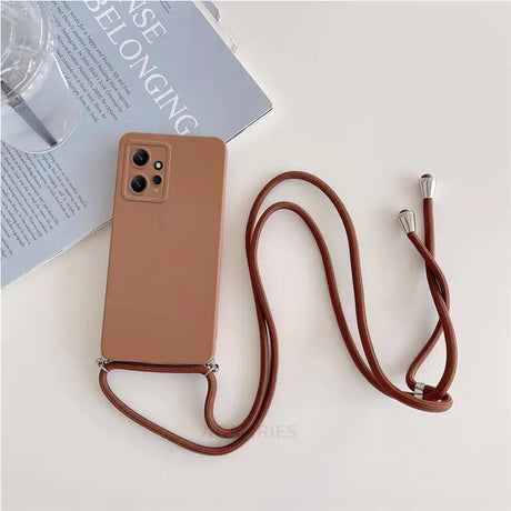 The brown leather phone case is attached to a brown leather strap