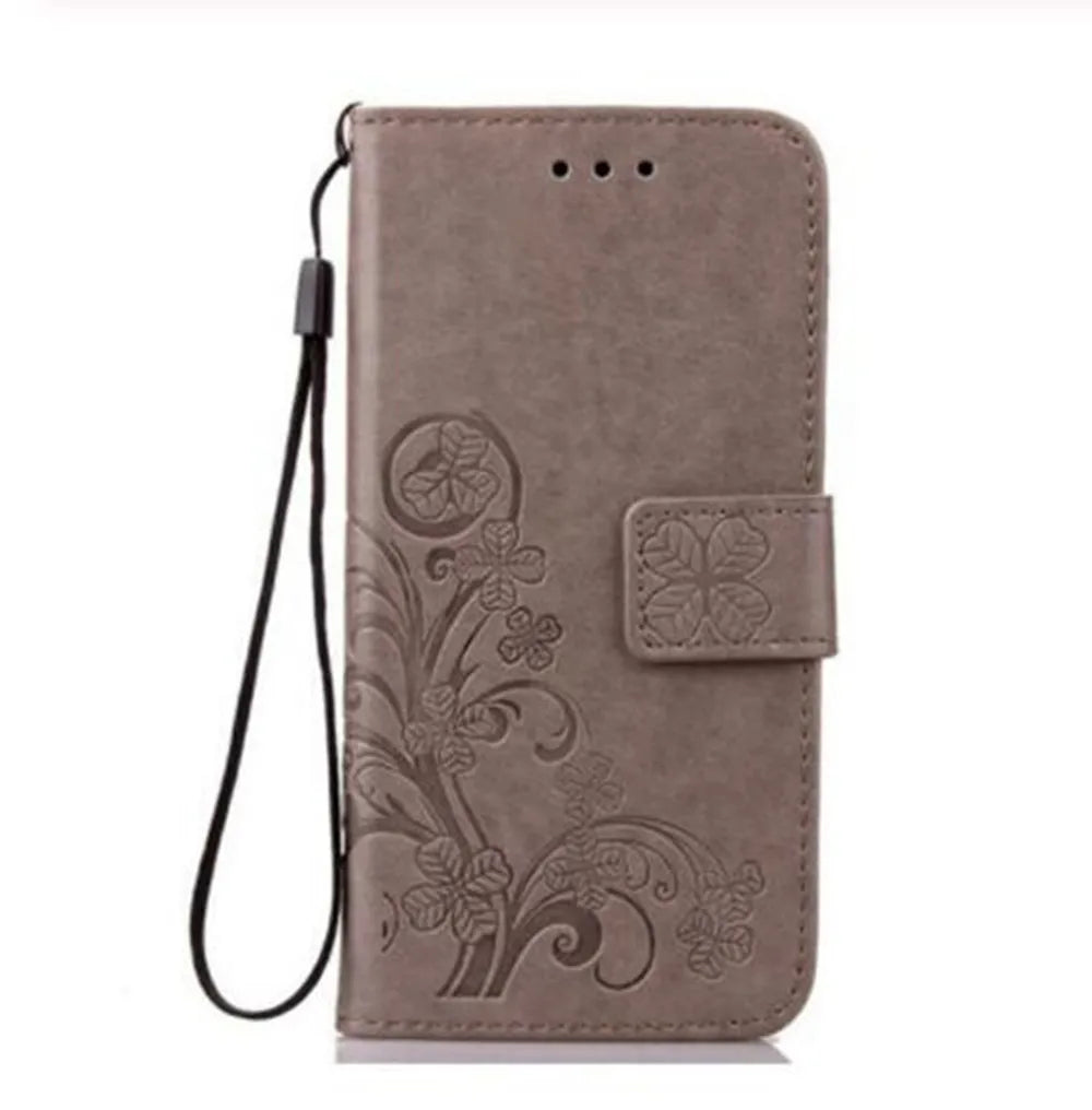 a brown leather wallet case with a flower design