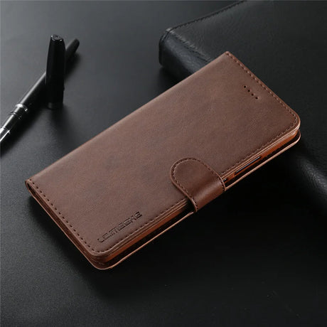 Brown leather wallet or phone case with a clasp closure.