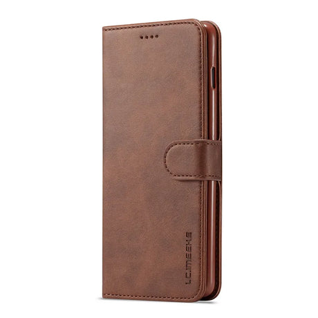 Brown leather wallet-style phone case with a closure strap.