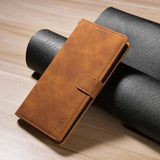 Brown leather wallet-style phone case with a closure flap.