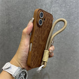 Brown leopard-print phone case with wrist strap.