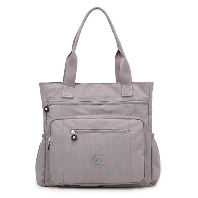 a grey bag with a zipper on the front and a zippered pocket