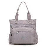 a grey bag with a zipper on the front and a zippered pocket