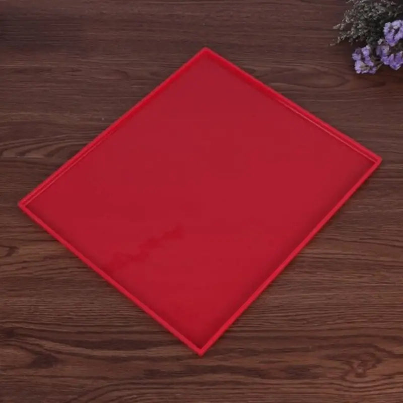 a red square plate on a wooden table