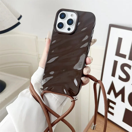 Brown patterned phone case with strap.