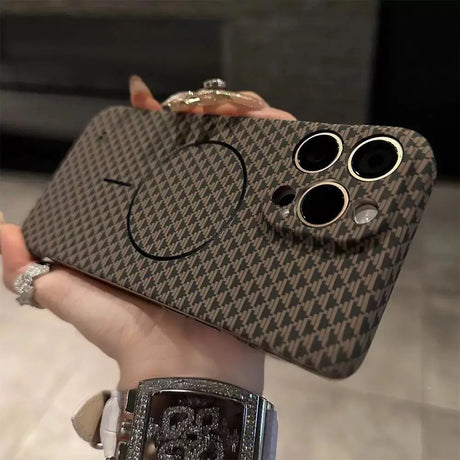 Brown patterned smartphone case with triple camera cutouts and a circular magnetic accessory.