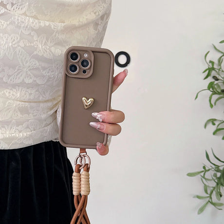 Brown phone case with heart charm and lanyard.