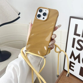 Brown phone case with yellow strap.