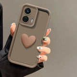 A brown smartphone case with a raised heart design and a camera cutout.