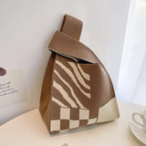 a brown and white bag sitting on top of a table