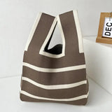 a brown and white striped bag sitting on a white table