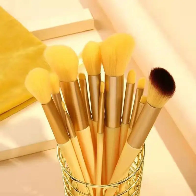 a glass with a bunch of makeup brushes