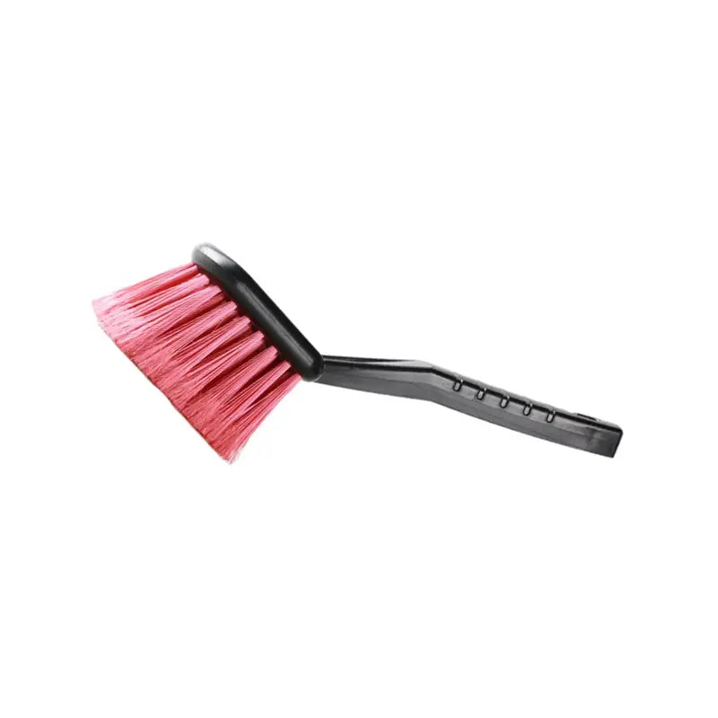 a brush with a pink handle