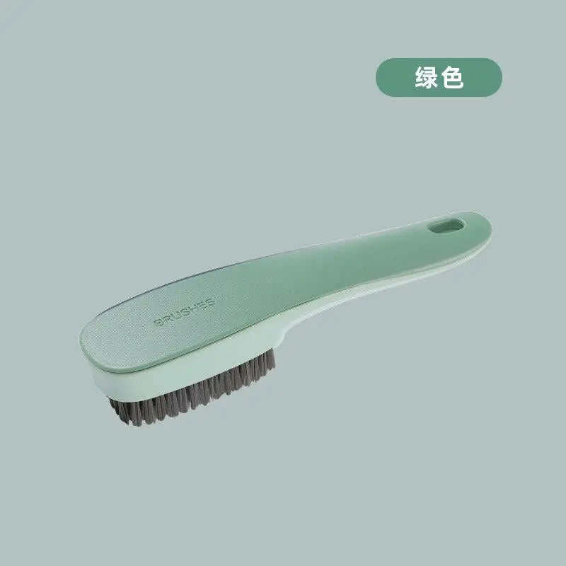 a brush with a green handle