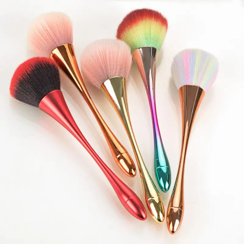 a close up of a group of makeup brushes on a white surface