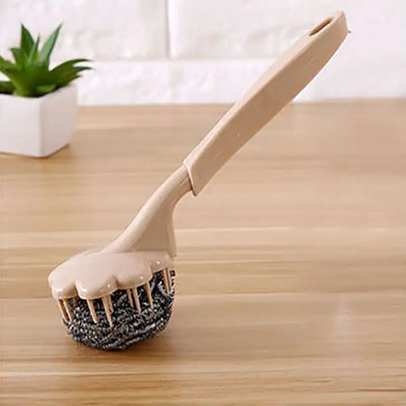 a brush with a wooden handle on a table