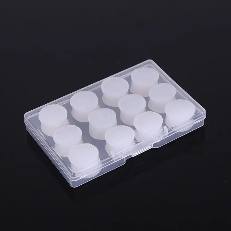 a clear plastic box with white candles inside