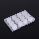 a clear plastic box with white candles inside