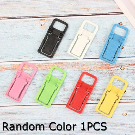 a bunch of colorful plastic clips on a white wooden background