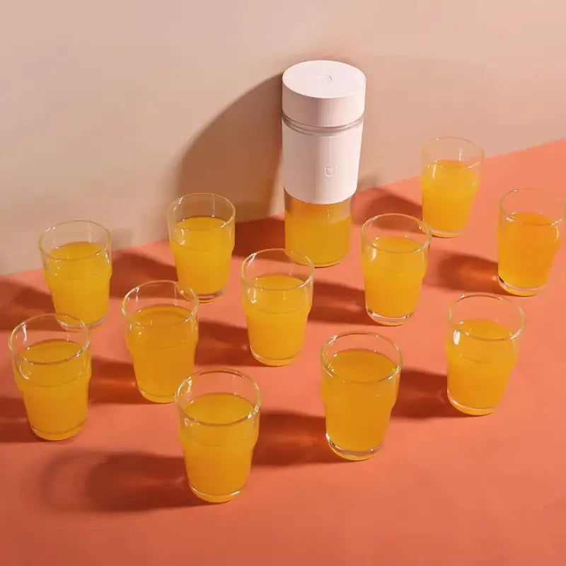 a bunch of glasses with a white container