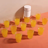 A bunch of glasses with a white container