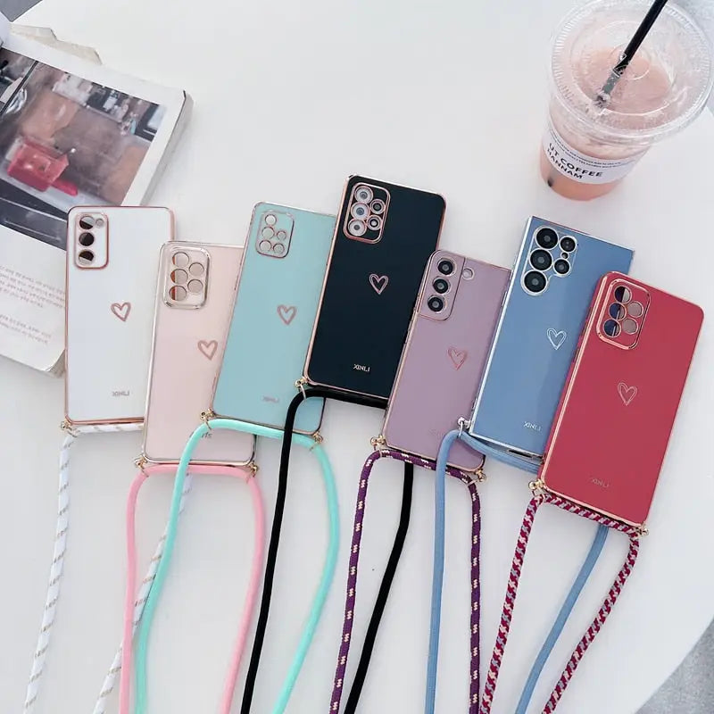 a bunch of iphone cases with a phone strap