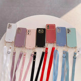 a bunch of iphone cases with a ribbon around them