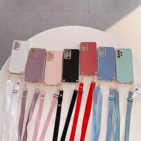 a bunch of phone cases with a ribbon around them