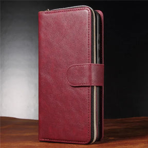 Burgundy leather wallet-style phone case with a zipper and snap closure.