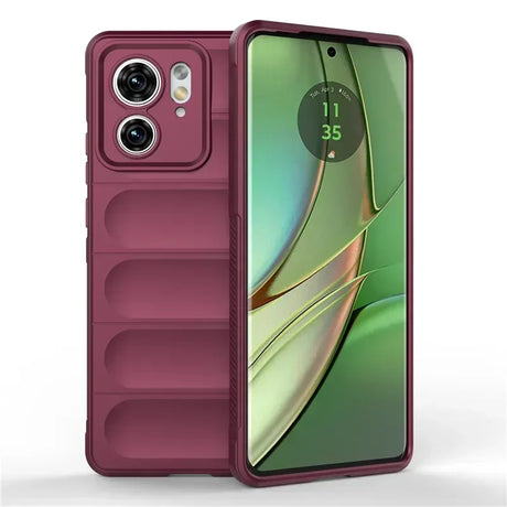 Burgundy smartphone in a protective case with a visible camera module and a screen displaying the time.