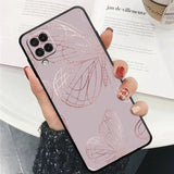a woman holding a phone case with a pink butterfly design