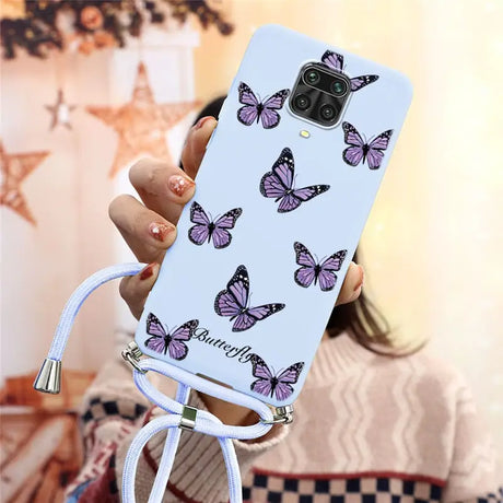 a woman holding a phone case with butterflies on it