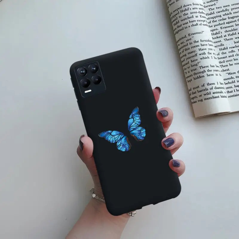 a woman holding a phone case with a blue butterfly on it