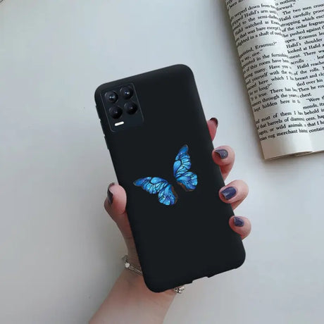 a woman holding a phone case with a blue butterfly on it