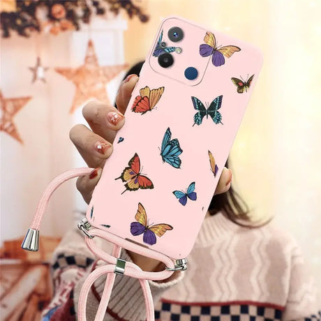 a woman holding a pink phone case with butterflies on it