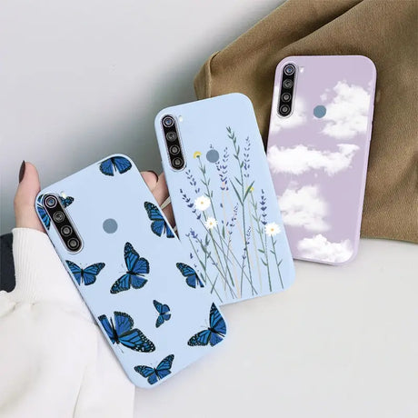 a woman holding a phone case with a blue butterfly pattern