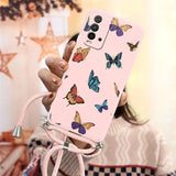 a woman holding a pink phone case with butterflies on it