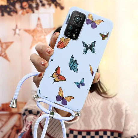 a woman holding a phone case with butterflies on it