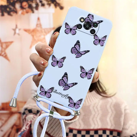 a woman holding a phone case with butterflies on it