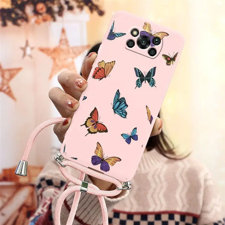 a woman holding a pink phone case with butterflies on it