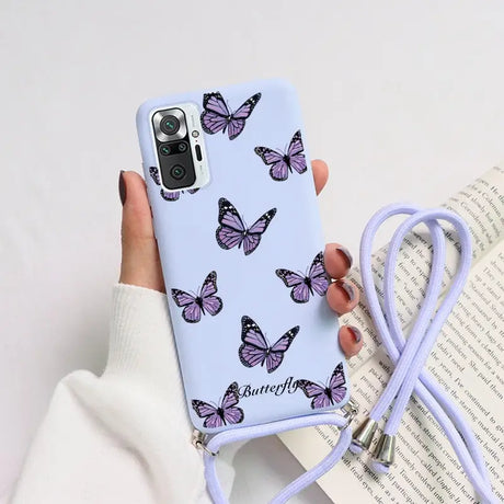 a woman holding a phone case with butterflies on it